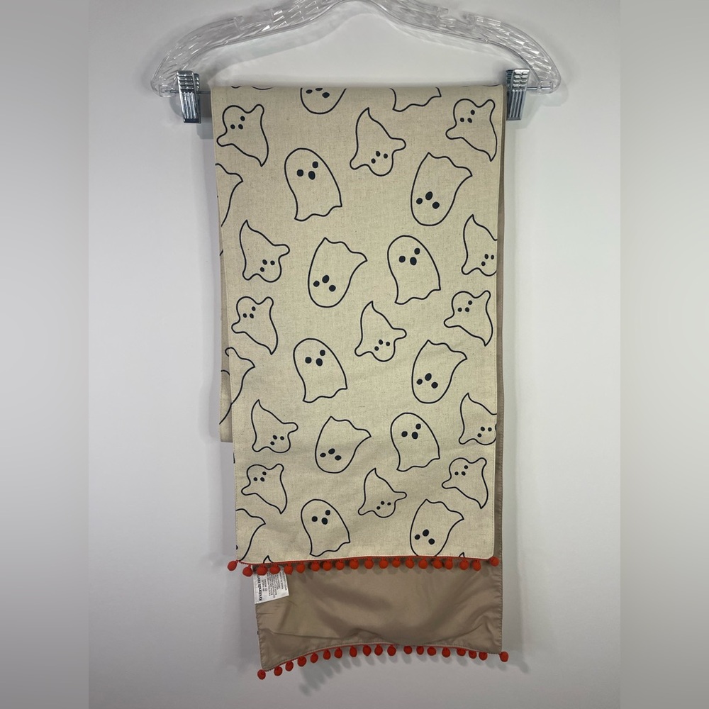 Kirkland's Home ghost Beige with Orange Pom Pom’s table runner